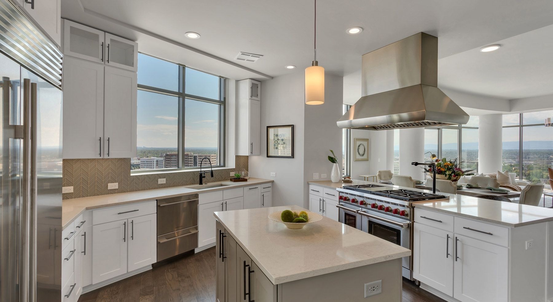 Wide open and bright kitchen area with high-up view of the city