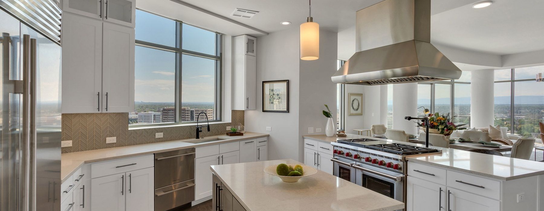 Wide open and bright kitchen area with high-up view of the city