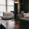 Spacious and well lit living room with hardwood floors and unique architectural accents
