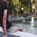 Woman lounging by the pool with her feet submerged and enjoying the view