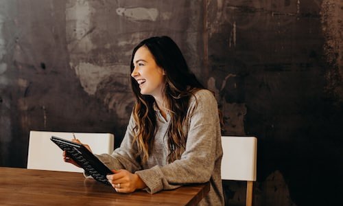 Woman laughing while working