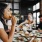 Young woman eating in a local restaurant surrounded by friends